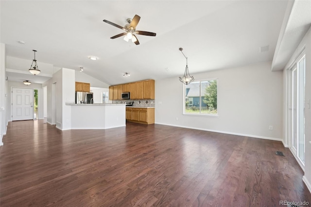 unfurnished living room featuring dark hardwood / wood-style flooring, vaulted ceiling, and ceiling fan