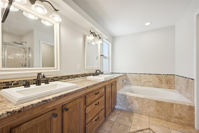 bathroom with plus walk in shower, tile patterned flooring, and vanity