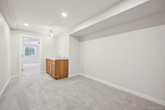 bar with a chandelier, sink, and light colored carpet