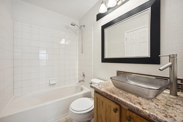 full bathroom with vanity, tiled shower / bath combo, and toilet