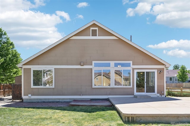 rear view of property featuring a yard and a patio