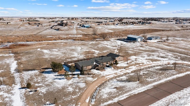 snowy aerial view featuring a rural view