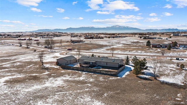 snowy aerial view featuring a mountain view