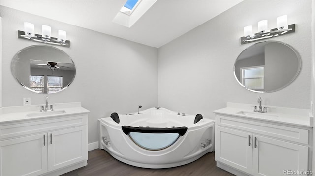 bathroom featuring vanity, a bath, and hardwood / wood-style floors