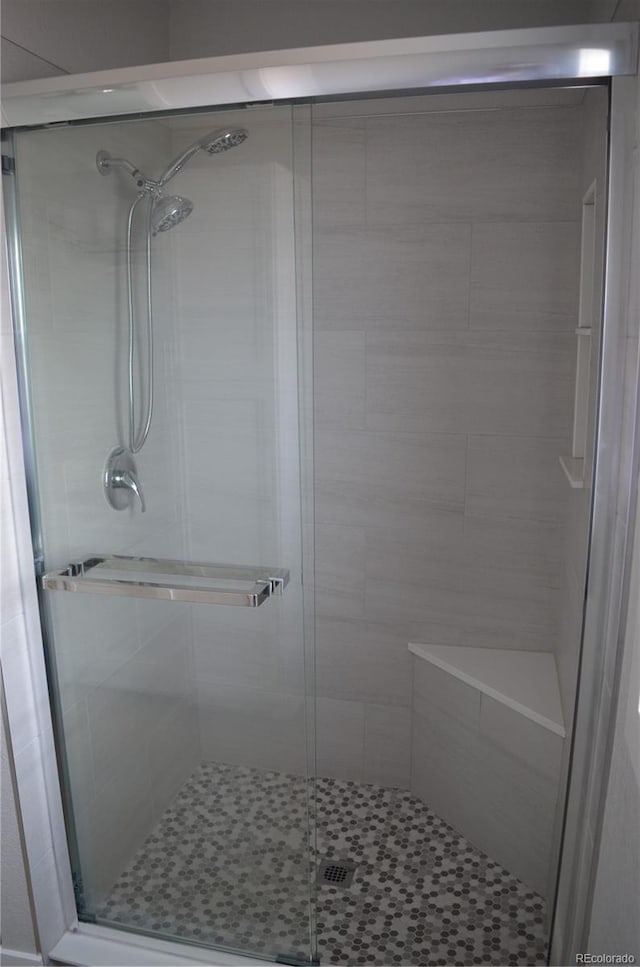 bathroom with a shower with door