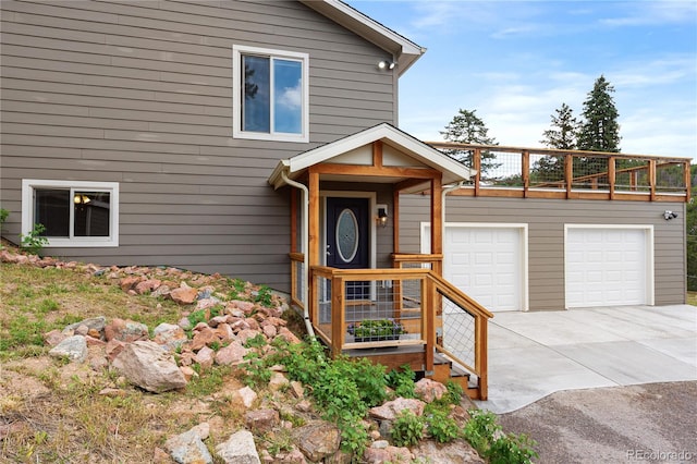 6773 Snowshoe Trl, Evergreen, CO 80439 - view of front of house featuring concrete driveway and a garage