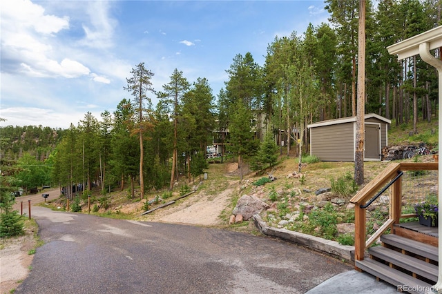 6773 Snowshoe Trl, Evergreen, CO 80439 - view of asphalt road with a view of trees