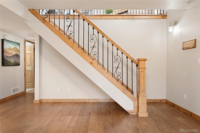 6773 Snowshoe Trl, Evergreen, CO 80439 - staircase featuring wood finished floors