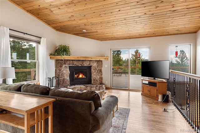 6773 Snowshoe Trl, Evergreen, CO 80439 - living room with wooden ceiling, healthy amount of natural light, a stone fireplace, light wood-type flooring, and lofted ceiling