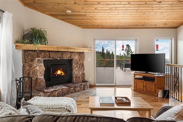 6773 Snowshoe Trl, Evergreen, CO 80439 - living area with wooden ceiling, a fireplace, light wood-style flooring, and lofted ceiling