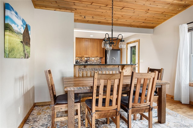 6773 Snowshoe Trl, Evergreen, CO 80439 - dining space with wooden ceiling, light wood-style floors, and a chandelier