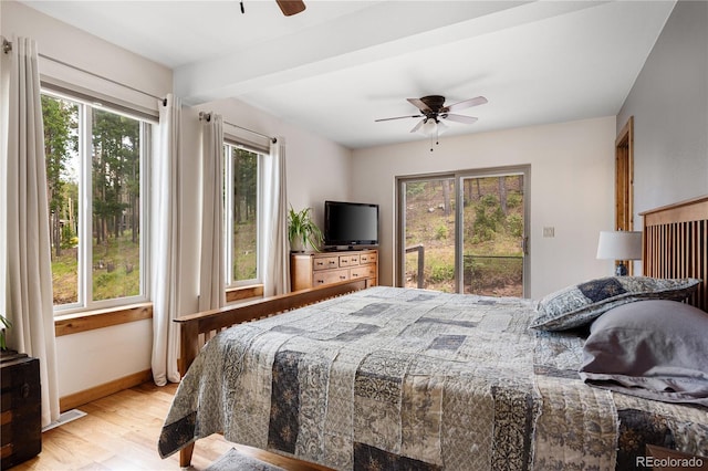 6773 Snowshoe Trl, Evergreen, CO 80439 - bedroom with light wood finished floors, a ceiling fan, and beamed ceiling