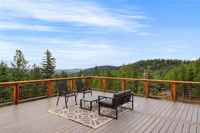 6773 Snowshoe Trl, Evergreen, CO 80439 - wooden deck with a mountain view and a view of trees
