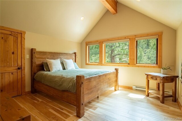 bedroom featuring light wood finished floors, vaulted ceiling with beams, and baseboards