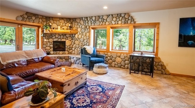 living area featuring recessed lighting, a fireplace, and baseboards