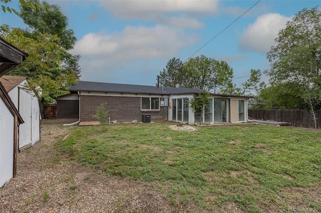 7042 W 76th Ave, Arvada, CO 80003 - rear view of property featuring brick siding and a sunroom