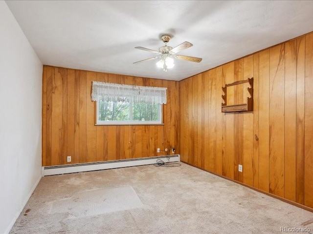 423 Empire St, Aurora, CO 80010 - empty room featuring baseboard heating, carpet flooring, ceiling fan, and wooden walls