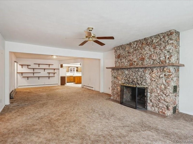 423 Empire St, Aurora, CO 80010 - unfurnished living room with a baseboard heating unit, carpet flooring, a ceiling fan, and a fireplace
