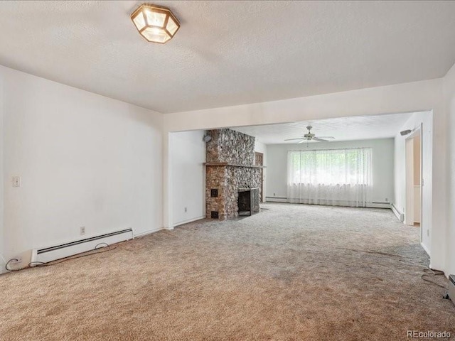 423 Empire St, Aurora, CO 80010 - unfurnished living room featuring a baseboard heating unit, carpet flooring, a textured ceiling, a stone fireplace, and ceiling fan