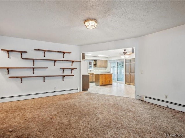 423 Empire St, Aurora, CO 80010 - unfurnished living room with a baseboard heating unit, light colored carpet, a textured ceiling, and ceiling fan