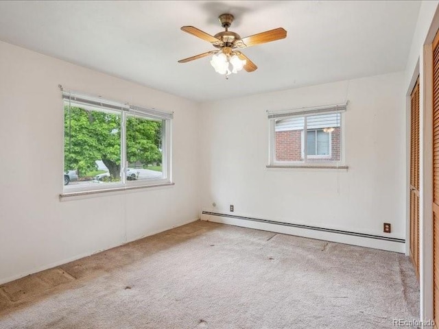 423 Empire St, Aurora, CO 80010 - empty room featuring a baseboard heating unit, carpet, and a ceiling fan