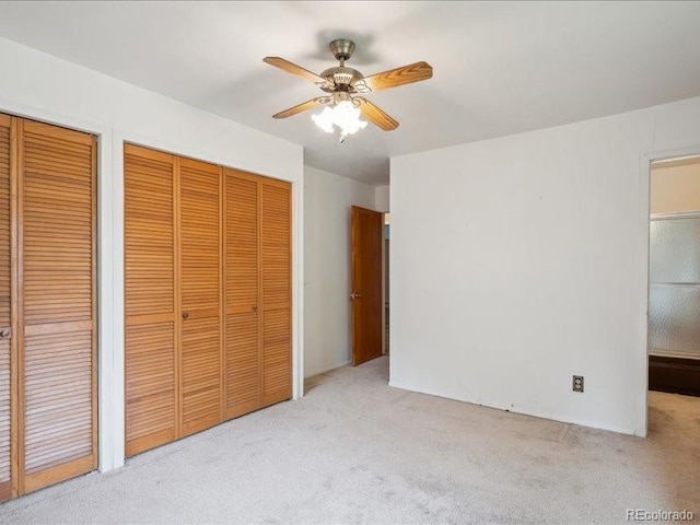 423 Empire St, Aurora, CO 80010 - unfurnished bedroom with carpet floors, multiple closets, and a ceiling fan
