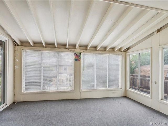 423 Empire St, Aurora, CO 80010 - unfurnished sunroom with vaulted ceiling and carpet flooring