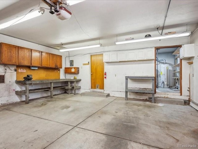 423 Empire St, Aurora, CO 80010 - garage featuring water heater, a garage door opener, and a workshop area