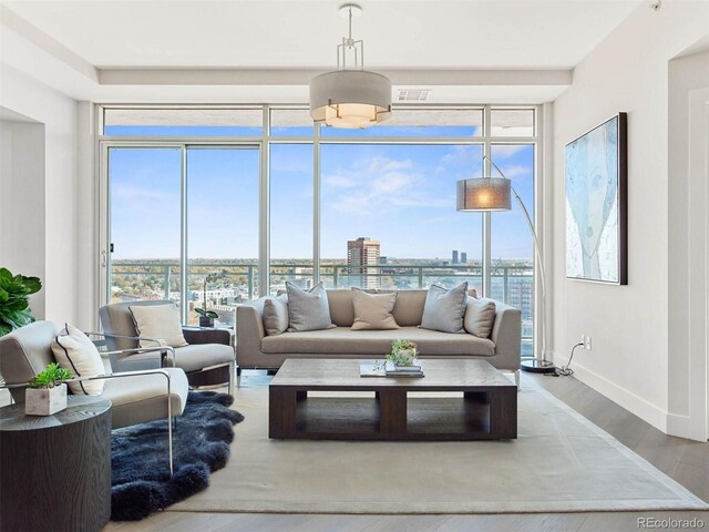 2001 Lincoln St Unit 1822, Denver, CO 80202 - living room featuring a city view, expansive windows, wood finished floors, baseboards, and visible vents