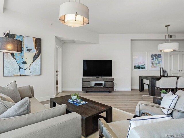 2001 Lincoln St Unit 1822, Denver, CO 80202 - living area featuring baseboards, visible vents, and wood finished floors