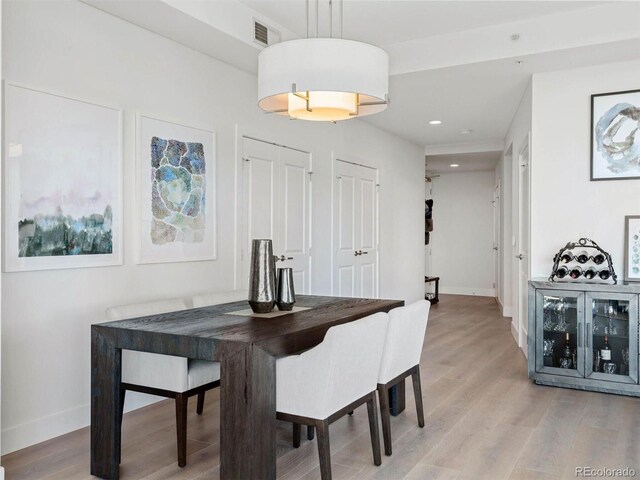 2001 Lincoln St Unit 1822, Denver, CO 80202 - dining room with light wood-type flooring, baseboards, and visible vents