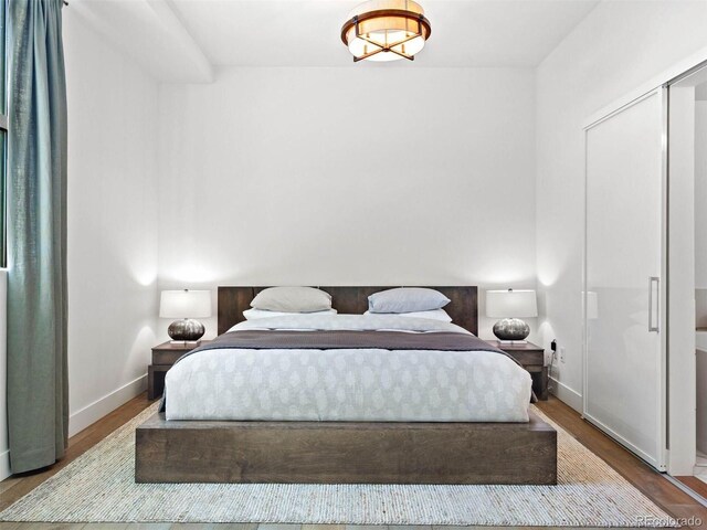 2001 Lincoln St Unit 1822, Denver, CO 80202 - bedroom with baseboards and wood finished floors