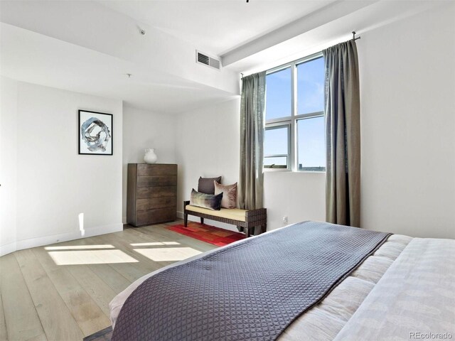 2001 Lincoln St Unit 1822, Denver, CO 80202 - bedroom with baseboards, visible vents, and hardwood / wood-style flooring