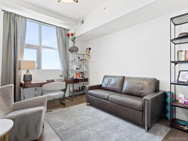 2001 Lincoln St Unit 1822, Denver, CO 80202 - living room featuring wood finished floors and visible vents