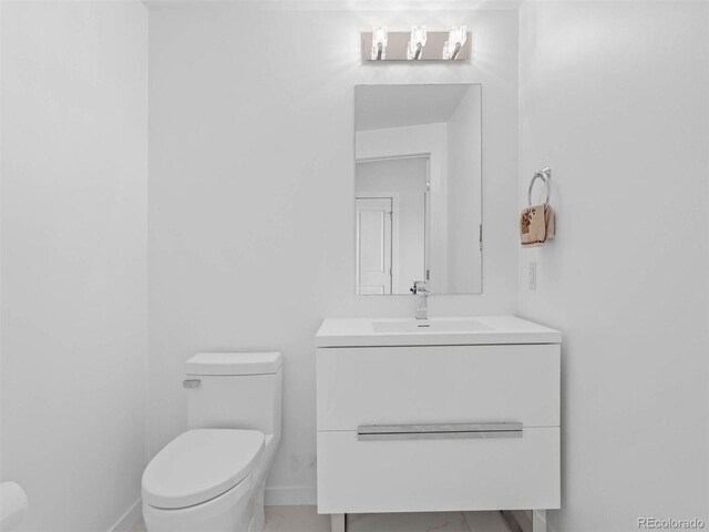2001 Lincoln St Unit 1822, Denver, CO 80202 - bathroom with baseboards, toilet, and vanity