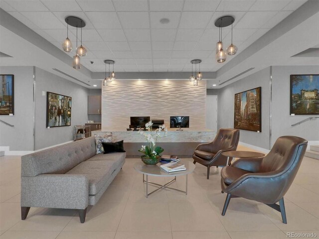 2001 Lincoln St Unit 1822, Denver, CO 80202 - tiled living room featuring baseboards, an accent wall, and a paneled ceiling