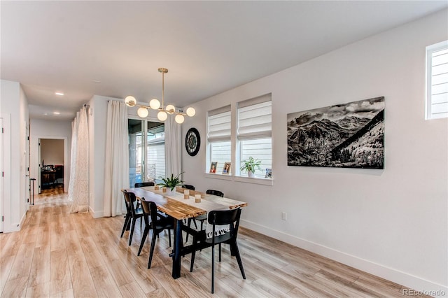 dining space featuring a chandelier, light hardwood / wood-style flooring, and a wealth of natural light