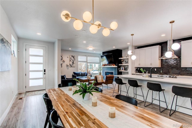 dining room with sink and light hardwood / wood-style flooring