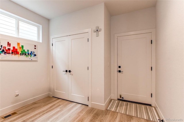 doorway to outside with light wood-type flooring