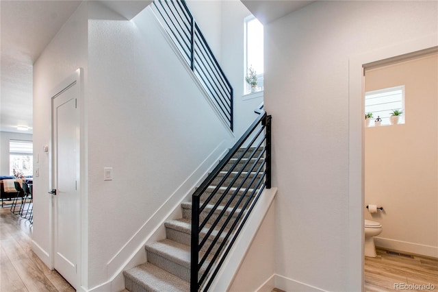 stairs featuring wood-type flooring