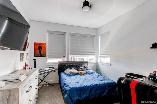 bedroom featuring light colored carpet and ceiling fan