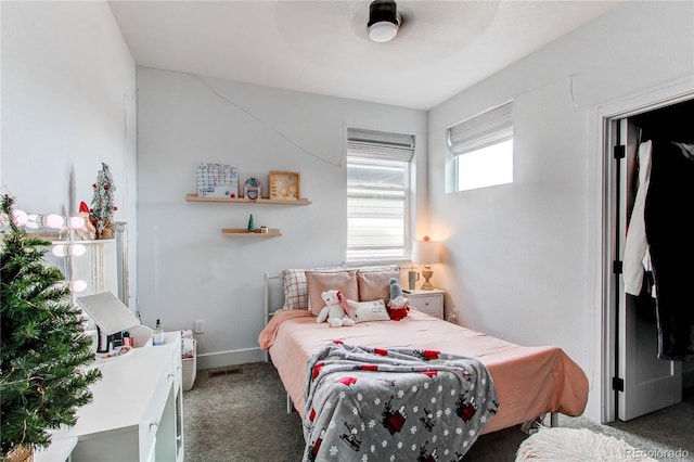 bedroom with ceiling fan and dark colored carpet