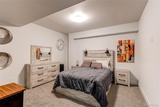 carpeted bedroom featuring a textured ceiling