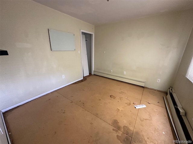 spare room with a baseboard radiator and concrete flooring