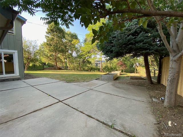 view of patio / terrace featuring a vegetable garden and fence