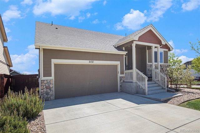 2137 Day Spring Dr, Windsor, CO 80550 - ranch-style house with stone siding, driveway, a shingled roof, and an attached garage