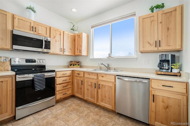 2137 Day Spring Dr, Windsor, CO 80550 - kitchen with appliances with stainless steel finishes, light brown cabinetry, a sink, and recessed lighting