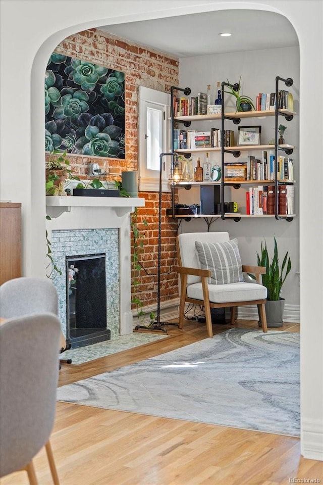 3384 W 29th Ave, Denver, CO 80211 - living area with brick wall, wood finished floors, arched walkways, and a large fireplace