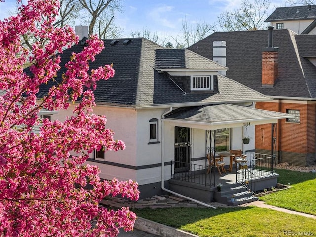 3384 W 29th Ave, Denver, CO 80211 - view of front facade featuring roof with shingles, a chimney, a porch, and a front lawn