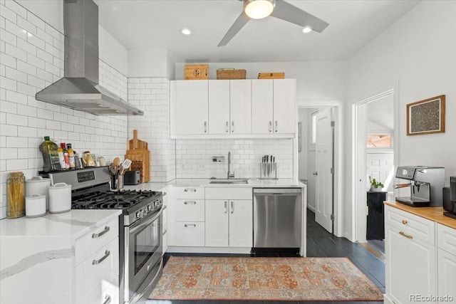 3384 W 29th Ave, Denver, CO 80211 - kitchen featuring appliances with stainless steel finishes, a sink, wall chimney range hood, white cabinetry, and recessed lighting